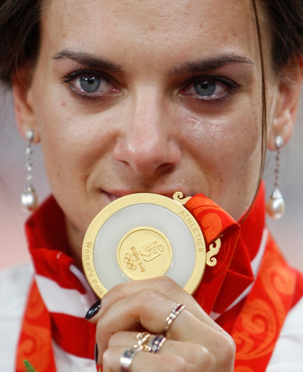FILE - In this Aug. 19, 2008 file photo Russian pole vaulter Yelena Isinbayeva shows her gold medal during an awarding ceremony of the women's pole vault in the National Stadium at the Beijing 2008 Olympics in Beijing. The Court of Arbitration for Sport will issue its verdict Thursday, July 21, 2016 on Russia's appeal to overturn the IAAF ban on its track and field athletes for the 2016 Rio Olympic Games. (AP Photo/Greg Baker, file)