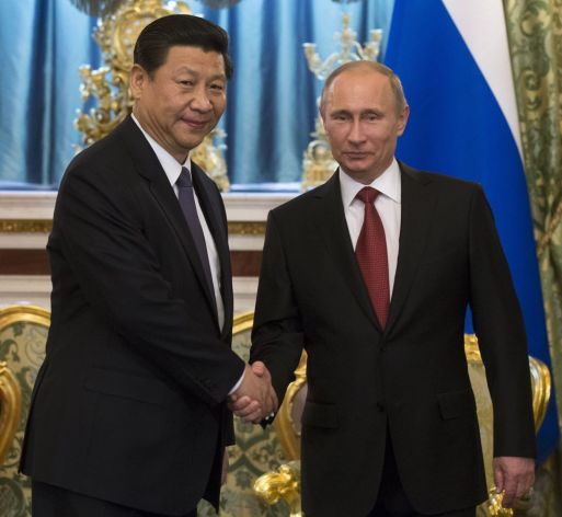 Putin and new chinese pres shake hands